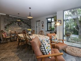 A dining room with a large table and chairs at Windyridge in Gwaenysgor, near Prestatyn
