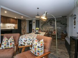 A dining room with a large table and chairs at Windyridge in Gwaenysgor, near Prestatyn