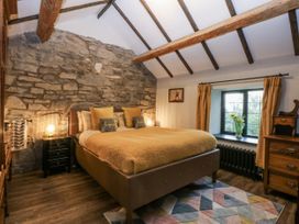 A bedroom with a bed and nightstand at Windyridge in Gwaenysgor, near Prestatyn