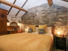 A bedroom with a bed and bedside table at Windyridge in Gwaenysgor, near Prestatyn