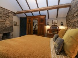 A bedroom with a bed and wooden furniture at Windyridge in Gwaenysgor, near Prestatyn