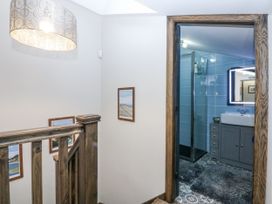 A bathroom entrance with a sink and shower at Windyridge in Gwaenysgor, near Prestatyn