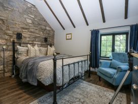 A bedroom with a bed and chair at Windyridge in Gwaenysgor, near Prestatyn