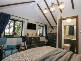 A bedroom with a bed and a dresser at Windyridge, Gwaenysgor, near Prestatyn