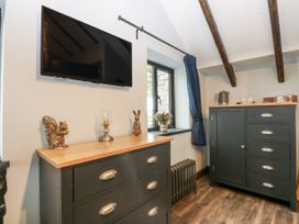 A bedroom with a television and furniture at Windyridge, Gwaenysgor, near Prestatyn