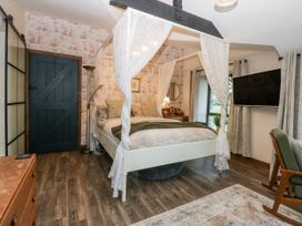 A bedroom with a bed and television at Windyridge Gwaenysgor near Prestatyn