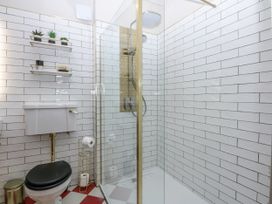 A bathroom with a shower and toilet at Windyridge in Gwaenysgor, near Prestatyn