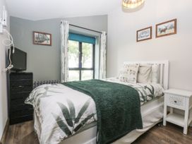 A bedroom with a bed and TV at Windyridge, Gwaenysgor, near Prestatyn