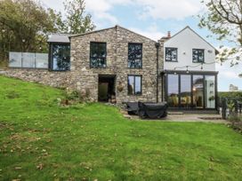 An outdoor view of a modern stone house at Windyridge in Gwaenysgor, near Prestatyn