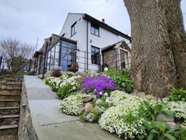 A house with flowers and stone steps at Windyridge, Gwaenysgor near Prestatyn