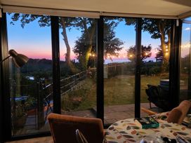 A dining area with glass doors opening to a garden at Windyridge in Gwaenysgor, near Prestatyn