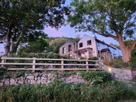 A house with a garden and stone wall at Windyridge, Gwaenysgor, near Prestatyn