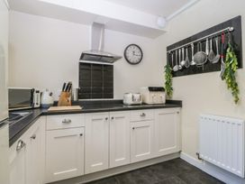 A kitchen with appliances and utensils at Mallards Rest in Llandwrog near Bontnewydd, Gwynedd