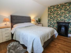 A bedroom with a bed and nightstands at Mallards Rest in Llandwrog near Bontnewydd, Gwynedd