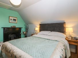 A bedroom with a bed and nightstand at Mallards Rest in Llandwrog near Bontnewydd, Gwynedd