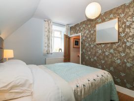 A bedroom with a bed and window at Mallards Rest in Llandwrog near Bontnewydd, Gwynedd