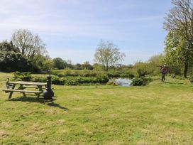 A garden with a picnic table and a water feature at Mallards Rest, Llandwrog near Bontnewydd, Gwynedd