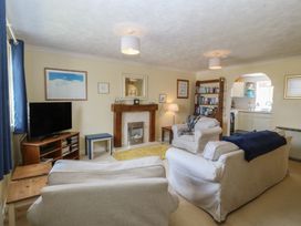 A living room with a television and fireplace at Wingelock in Rhosneigr