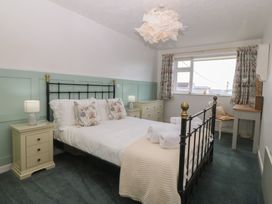 A bedroom with a bed and bedside tables at Wingelock in Rhosneigr