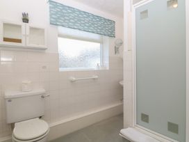 A bathroom with a shower and toilet at Wingelock in Rhosneigr