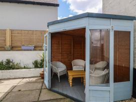 A garden structure with chairs and a table at Wingelock in Rhosneigr