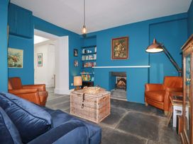 A living room with a sofa and two armchairs at 84 Fore Street