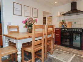 A kitchen with a dining table and chairs at 84 Fore Street