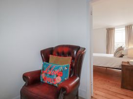 An armchair with a cushion in a bedroom at 84 Fore Street