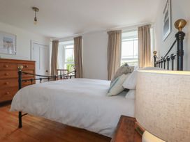 A bedroom with a bed and wooden furniture at 84 Fore Street