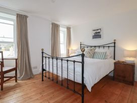 A bedroom with a bed and bedside table at 84 Fore Street