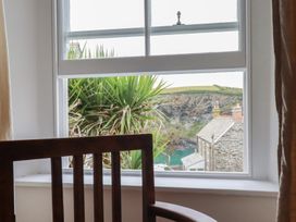 A window with a view of a plant and buildings at 84 Fore Street 