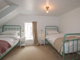 A bedroom with two beds and a window at 84 Fore Street