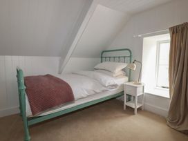 A bedroom with a bed and nightstand at 84 Fore Street