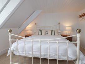 A bedroom with a bed and nightstands at 84 Fore Street