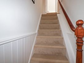 A staircase with carpet and handrail at 84 Fore Street