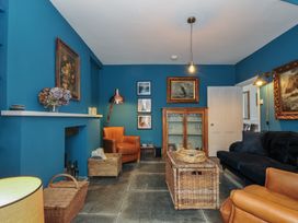 A living room with furniture and artwork at 84 Fore Street in Port Isaac