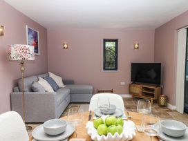 A dining room with a table and sofa at Harescombe Lodge in Morchard Bishop