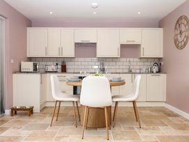 A kitchen with a table and chairs at Harescombe Lodge Morchard Bishop