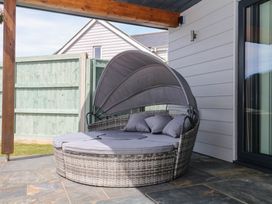 An outdoor sofa with a canopy at Harescombe Lodge in Morchard Bishop