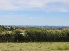 A landscape view with fields and trees at Harescombe Lodge in Morchard Bishop