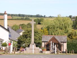 A cross and building in a rural setting at Harescombe Lodge in Morchard Bishop