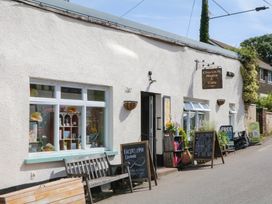 A store and cafe with benches and signage at Church St Stores in Morchard Bishop