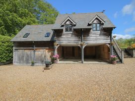 A garage with steps and a potted plant at Pultheley Cottage in Hyssington near Churchstoke