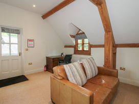 A snug with a desk and an armchair at Pultheley Cottage Hyssington near Churchstoke