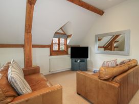 A living room with a television and sofas at Pultheley Cottage in Hyssington near Churchstoke