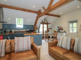 A living room with kitchen and dining area at Pultheley Cottage Hyssington near Churchstoke