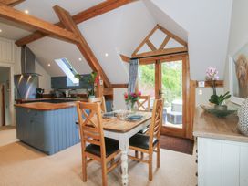 A kitchen with a dining table and chairs at Pultheley Cottage in Hyssington near Churchstoke