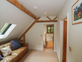 A living room with a sofa and artwork at Pultheley Cottage Hyssington near Churchstoke