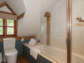 A bathroom with a toilet and bathtub at Pultheley Cottage in Hyssington near Churchstoke