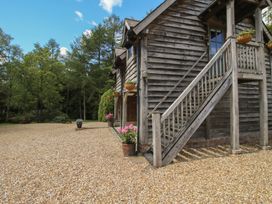 A wooden building with stairs and gravel area at Pultheley Cottage near Hyssington